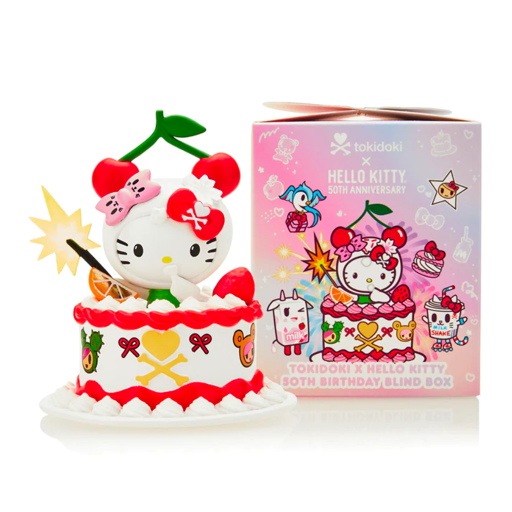 A Tokidoki x Hello Kitty figure atop a decorated cake, with the Tokidoki x Hello Kitty 50th Birthday Blind Box Series placed beside it, showcasing colorful designs celebrating Hello Kitty's 50th anniversary.