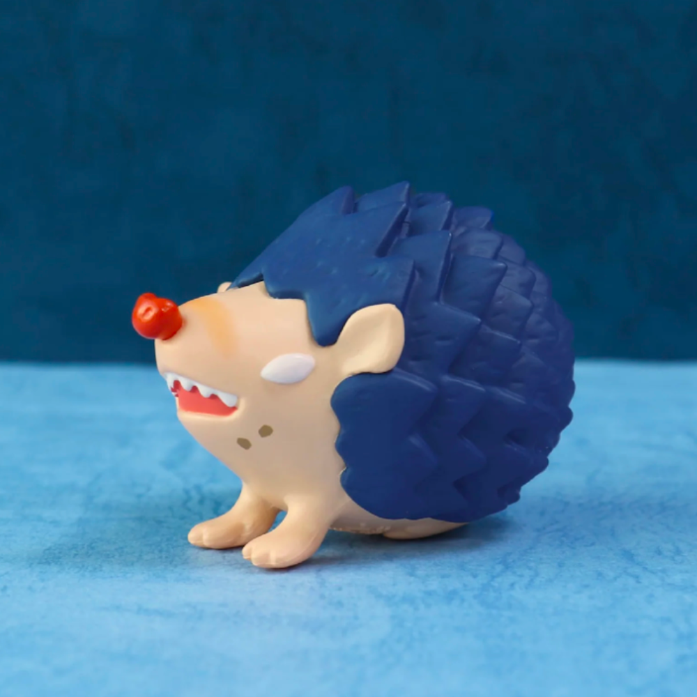 This Good Hedgehog/Bad Hedgehog Blind Box, brought to you by Partner Toys, offers a charming toy hedgehog figure with a pure heart. It has a round body, blue spiky back, and a red nose against a soothing blue background. It's akin to uncovering an unexpected delight from a blind box.