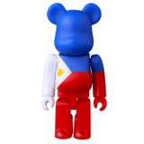 The Be@rbrick Series 49 Blind Box by Medicom (JP) features a toy bear figurine inspired by the Philippine flag, showcasing blue, red, and white colors with a yellow sun and stars—ideal for collectors and fans.