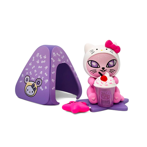 The Tokidoki Sugar Whiskers — Galactic Cats x Hello Kitty & Friends Special Edition features a limited-edition pink and white cat figurine with a bow, next to a purple tent, a pink drink, and paw biscuit on a purple mat.