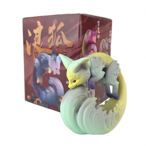 A pastel fox figurine with multiple tails stands before a Rōko Blind Box from Partner Toys, which features matching fox artwork and Japanese text, capturing the thrill of unboxing a surprise design each time.