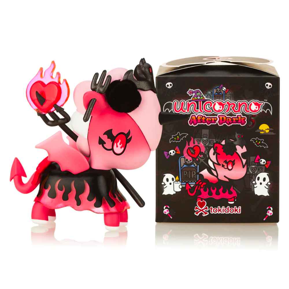 A pink and black unicorn figurine with devil horns and a pitchfork stands next to a box labeled 