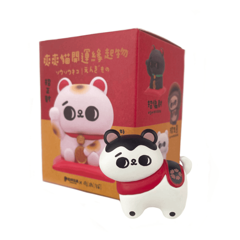 A small, cartoon-style cat figurine with a red scarf from Partner Toys’ Song Song Meow — Good Luck Charm Blind Box stands before a matching box with cat illustrations and Japanese text, adding a lucky surprise element.