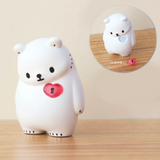 On a wooden surface, a Bac Bac is Thinking About (Polar Bear) Blind Box figurine, featuring a white polar bear with a pink heart lock on its chest, captures the essence of lonely hearts. An inset provides a close-up from another angle, reflecting the anticipation and surprise that comes with each blind box from Partner Toys (TW).