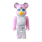 A pink and white Be@rbrick from Medicom's Be@rbrick Series 50 Blind Box features bird-like details, blue eyes, and a yellow beak, standing upright against a white background—ideal for collectors.