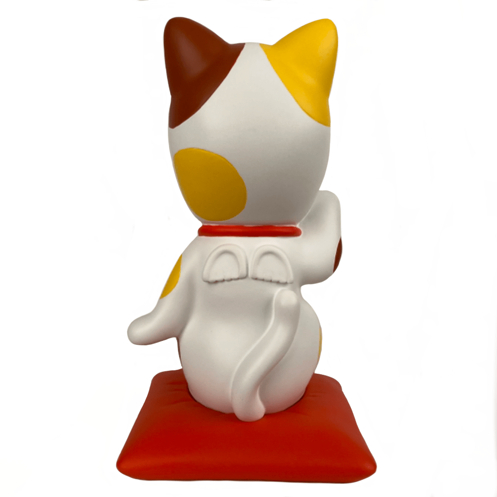 A collectible Dreams Sonny Angel — Lucky Cat Collectors Trophy figurine of a cat sitting on a red and yellow base.