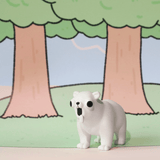 A white toy bear with exaggerated black eyes and open mouth stands on a pastel green surface before a cartoon forest, resembling one of the quirky figures from the Godgwawa — Weird Animals Blind Box by Partner Toys.