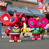 A pair of pink and purple elephants from the Finding Unicorn Yeaohua - American Vintage Blind Box series are standing in front of a street.