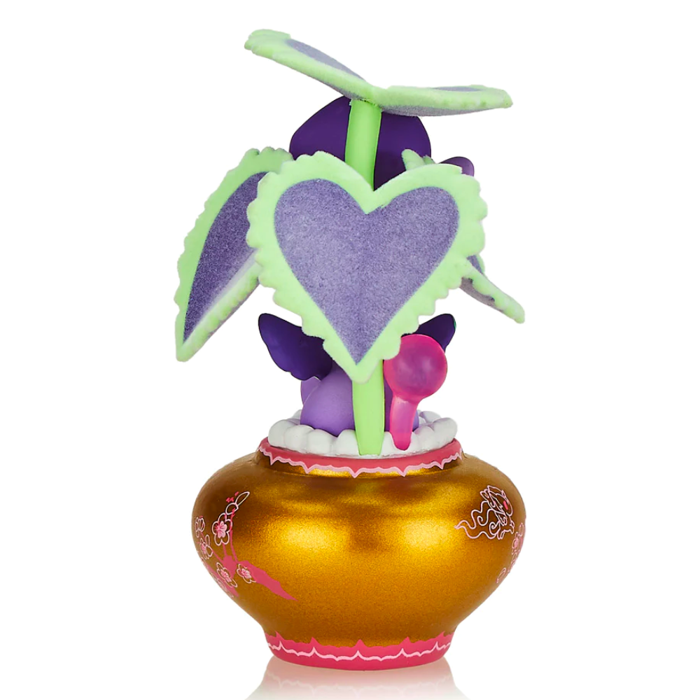 A small, whimsical plant toy with heart-shaped leaves in a decorative golden pot with ornate designs, the Tokidoki Botanical Unicorno - Piantina (Special Edition) by tokidoki (IT) is a one-of-a-kind gem.