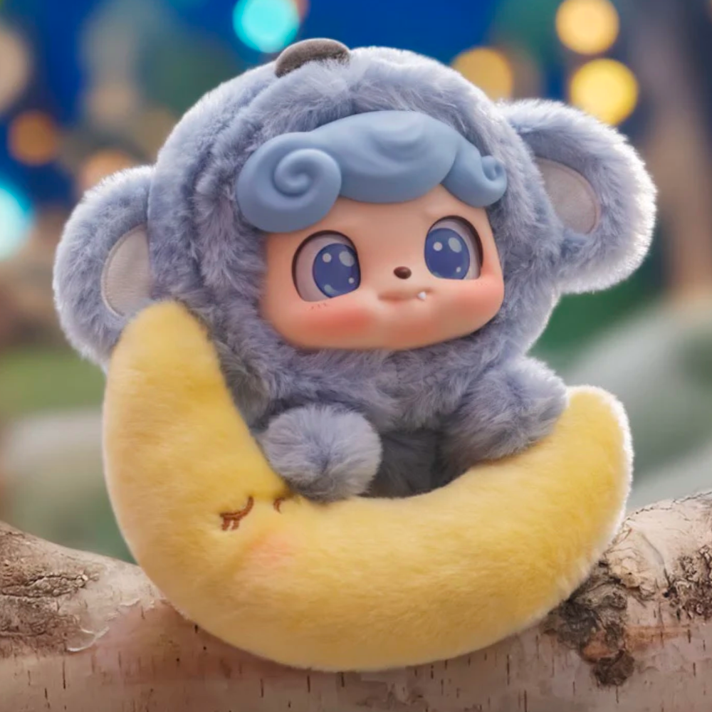 The Jotoys Q.Kid Animal PreSchool Plush Blind Box features a plush toy with big eyes in an adorable costume, sitting on a yellow crescent-shaped pillow with a sleepy face, set against a bokeh-lit background.