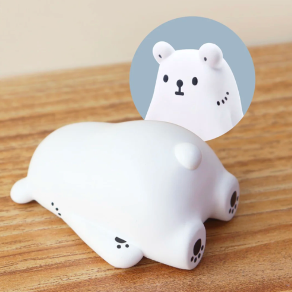 On a wooden surface rests the adorable Bac Bac is Thinking About (Polar Bear) Blind Box from Partner Toys (TW), designed to resemble a heartwarming bear-shaped door stopper. A close-up of its face, showcased in a circular inset, captures charm that even the loneliest hearts can't resist.