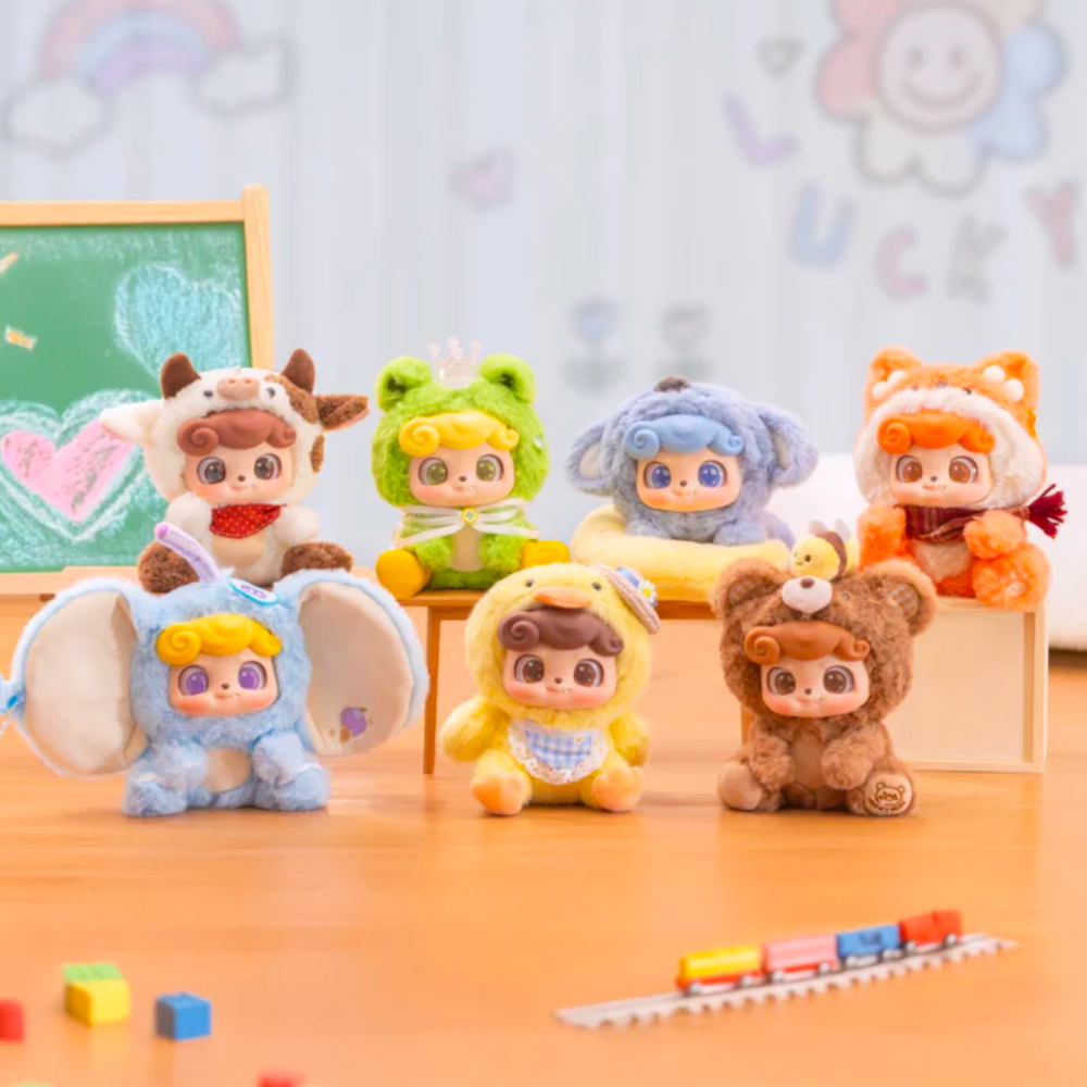 A set of seven Q.Kid Animal PreSchool Plush Blind Box toys by Jotoys, dressed in adorable animal costumes, sit charmingly on a wooden surface. Behind them, a small chalkboard with colorful drawings enhances the playful and whimsical atmosphere.