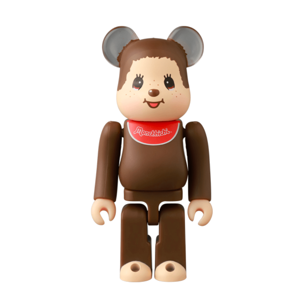 A Medicom (JP) Be@rbrick Series 50 Blind Box toy features a bear-like figure with round ears and a red “Monchhichi” bib, posed upright against a white background—ideal for collectors and fans of unique surprises.
