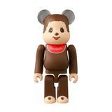A Medicom (JP) Be@rbrick Series 50 Blind Box toy features a bear-like figure with round ears and a red “Monchhichi” bib, posed upright against a white background—ideal for collectors and fans of unique surprises.