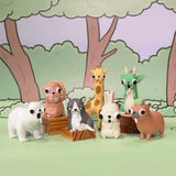Seven large-eyed animal figurines, including unusual ones like a capybara and dragon, are displayed before a cartoon forest. Each Godgwawa — Weird Animals Blind Box by Partner Toys contains one random collectible design.