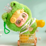 The Q.Kid Animal PreSchool Plush Blind Box by Jotoys features a playful plush toy in a charming frog-themed outfit and crown, resting in a small wooden cart on a light blue backdrop.