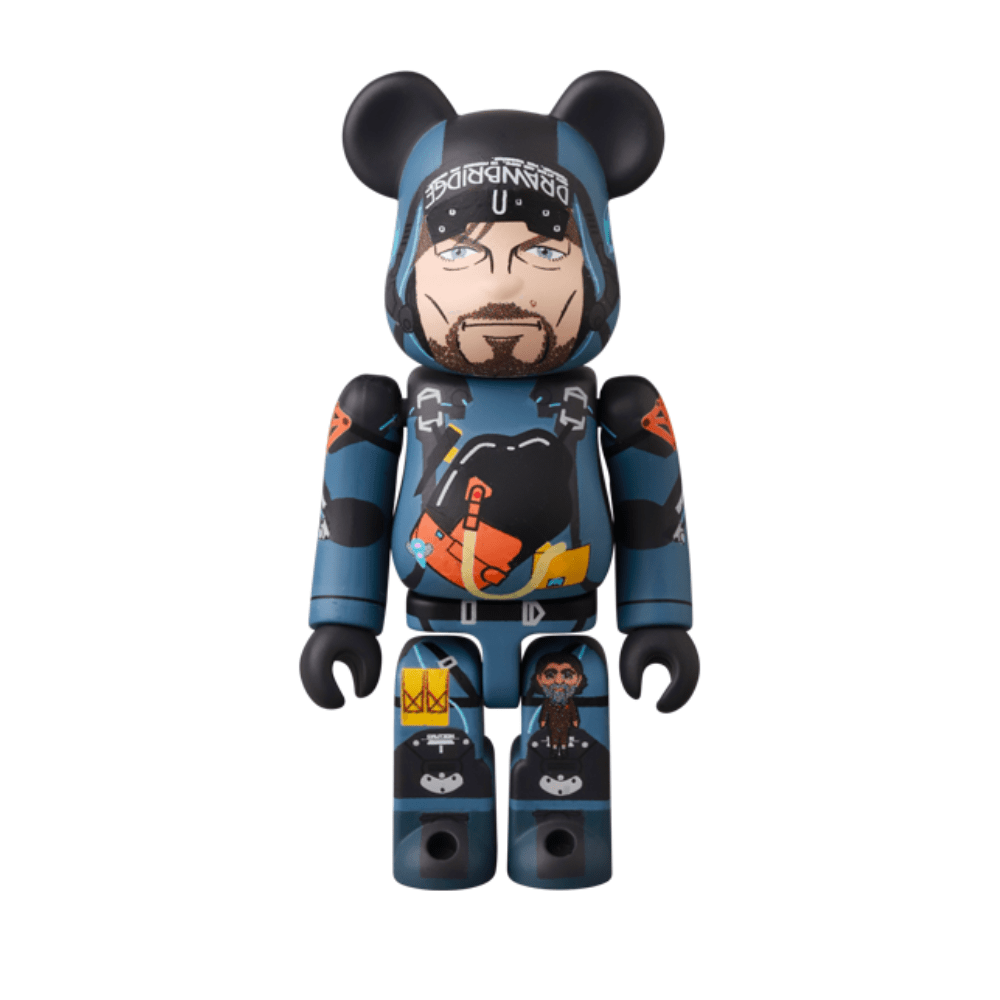 The Medicom (JP) Be@rbrick Series 50 Blind Box features a bearded man with blue and black clothing, orange and yellow highlights, and black bear ears—ideal for Bearbrick collectors or blind box fans.