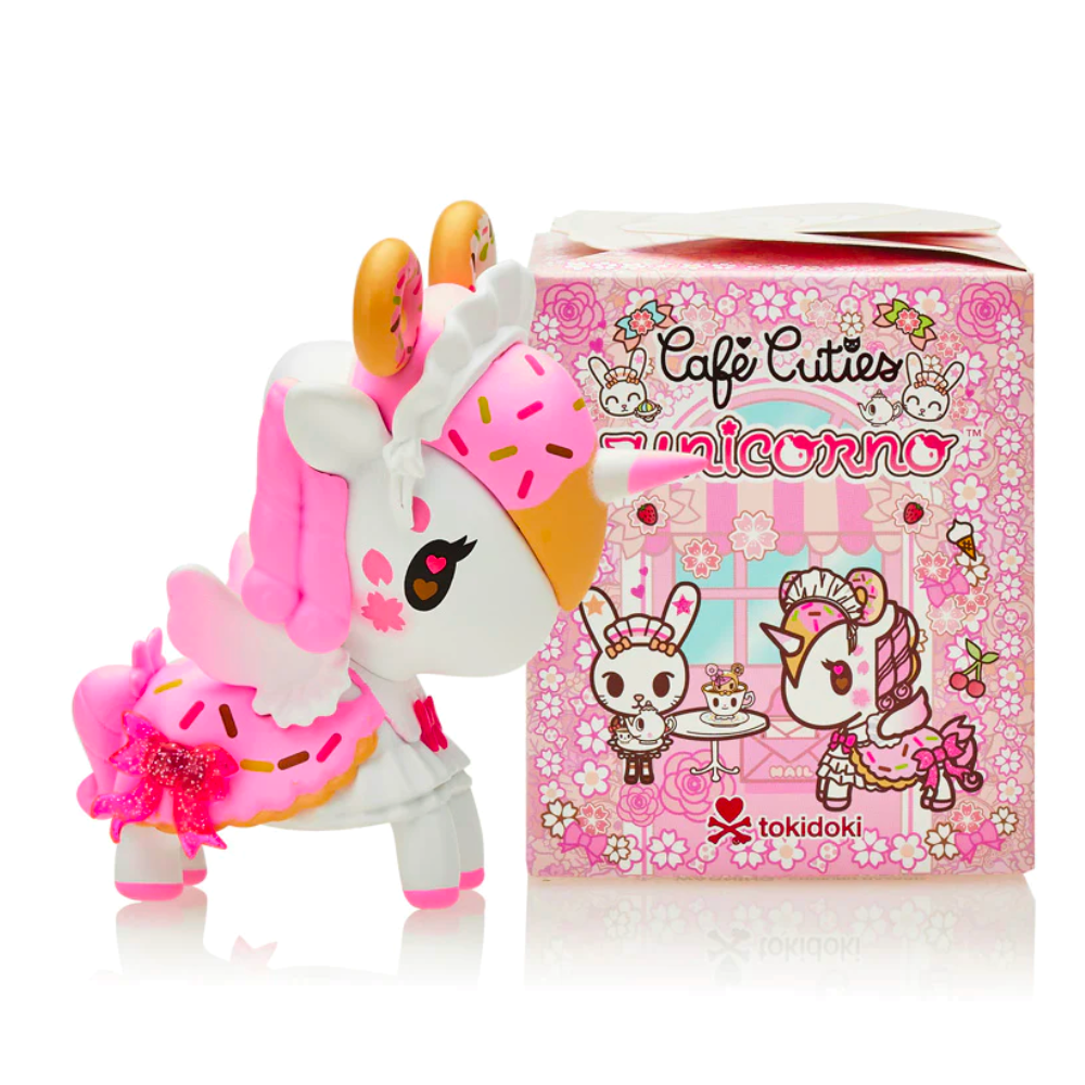 A small figurine of a pink and white unicorn stands next to a box labeled 