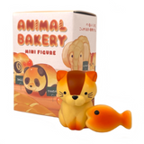 A mini figure of an orange cat with a fish beside it. The background showcases a 