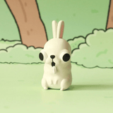 The Godgwawa — Weird Animals Blind Box by Partner Toys features a small, white cartoon bunny figurine with big black eyes and buck teeth, adding quirky charm to any whimsical illustrated forest scene.