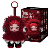 The Pop Mart You Found Me Skullpanda - Plush Figure Blind Box features a red and black plush doll pendant with a round red face, keyring, and curly hair, displayed next to its packaging box which showcases the same Skullpanda design along with others from the series on a theatrical red backdrop—making it an adorable accessory for your bag or collectible display.
