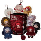 Eight plush figures with large eyes and fluffy costumes are arranged around a black “You Found Me Skullpanda - Plush Figure Blind Box” by Pop Mart in the center. These adorable Skullpanda plush bag charms come in a range of colors—including red, white, blue, brown, and black—making each one a delightful accessory to liven up any collection.