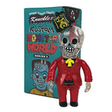 A toy figure resembling a skeleton in a red suit with black bowtie sits in front of the colorful 