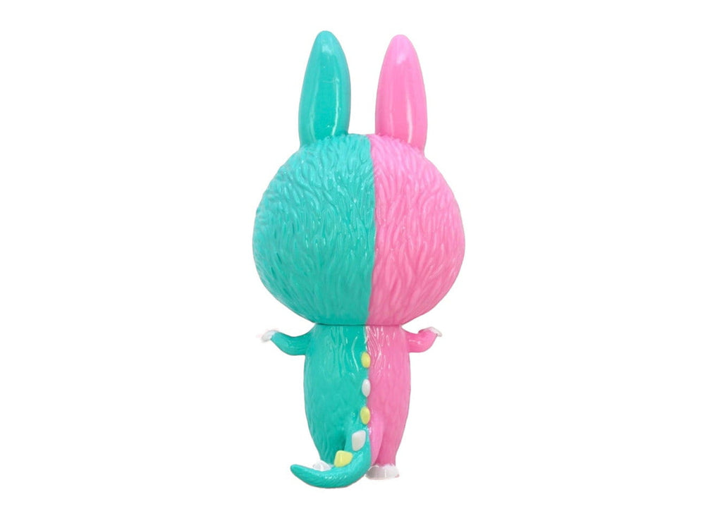 The Mini Zimomo- Endless by Rotofugi is a pocket-sized figure with a furry teal and pink texture, two upright ears, a tail, and stands with its back facing the viewer.