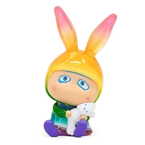 A small, colorful figurine with large rabbit-like ears, wearing a green outfit, sits and holds a white object with blue dots. The product name is A-Boy — A Coral by How2Work (HK).