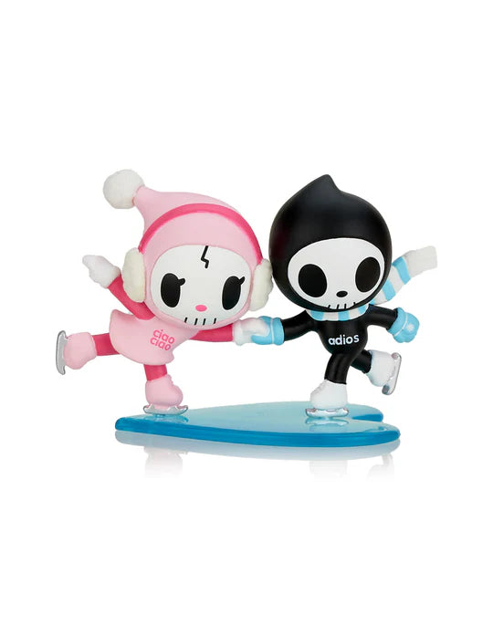 Two cartoon characters, Adios & Ciao Ciao, one in pink and the other in black, are ice skating together on a blue base. The character in pink has 