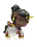 A miniature figure from the Tokidoki x Arcane League of Legends Unicorno Blind Box showcases an enchanting unicorn, standing proudly on four legs. It features a dark complexion, intricate braided hair, and shimmering gold accents. The unicorn is adorned with a white and gold cape, complemented by a striking green eye and a gleaming gold horn, making it an ideal addition for collectors of Unicorno Blind Boxes from the Tokidoki brand.