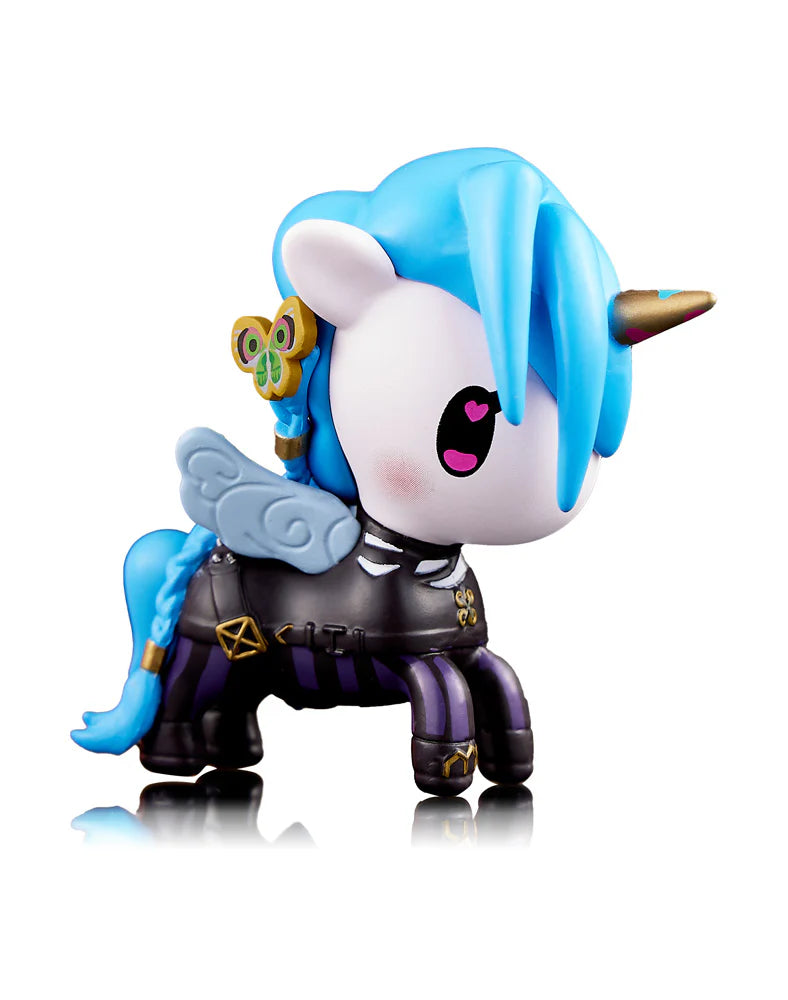 The Tokidoki x Arcane League of Legends Unicorno Blind Box features a whimsical unicorn figure adorned with blue hair, a horn, wings, and vibrant decorations, all standing on four legs in magical style.