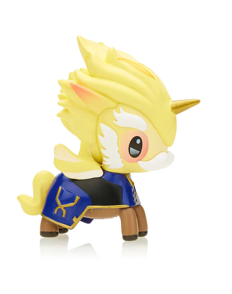 A captivating Unicorno figurine, featuring a mystical blend of yellow and white with golden hair and a striking blue and black outfit, majestically stands on its four brown legs. This piece, part of the exclusive 