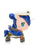 Explore the captivating realm of the Tokidoki x Arcane League of Legends Unicorno Blind Box with this small unicorn figurine. It features navy blue hair and attire, blue eyes, and a white hat, making it an essential item for any collector.