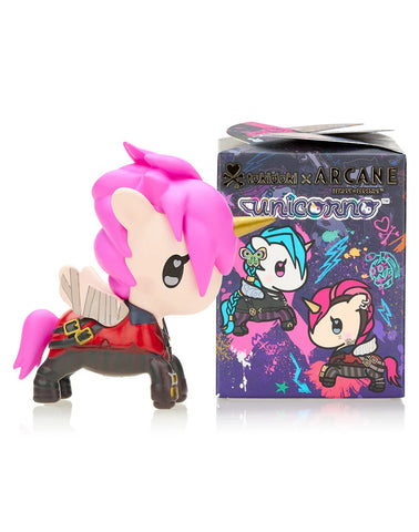 A vinyl collectible figure with pink hair and wings stands next to the vibrant Tokidoki x Arcane League of Legends Unicorno Blind Box, highlighting unicorn-themed characters from the collaboration between tokidoki and Arcane.