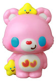 The VAG 42 — Care Bears by Medicom (JP) is a pink bear figurine with blue eyes, holding a yellow star and wearing another on its head—both smiling. Heart shapes decorate its belly, capturing the charm of Japanese vinyl gachapon collectibles.