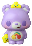 The VAG 42 — Care Bears by Medicom (JP) is a purple bear vinyl gachapon figure featuring rainbow and flowers on its belly, holding a yellow star and wearing another on its head—a cute Japanese collectible toy.