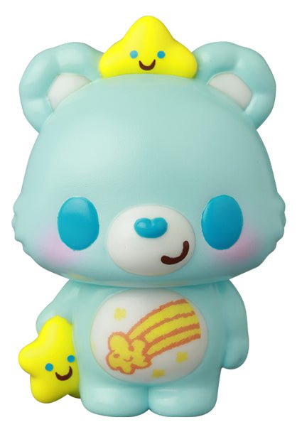 The VAG 42 — Care Bears by Medicom (JP) is a light blue bear vinyl toy with blue cheeks, a smiling face, and shooting star belly design. It holds a yellow star and has another on its head, inspired by Japanese vinyl artists and gacha collectibles.