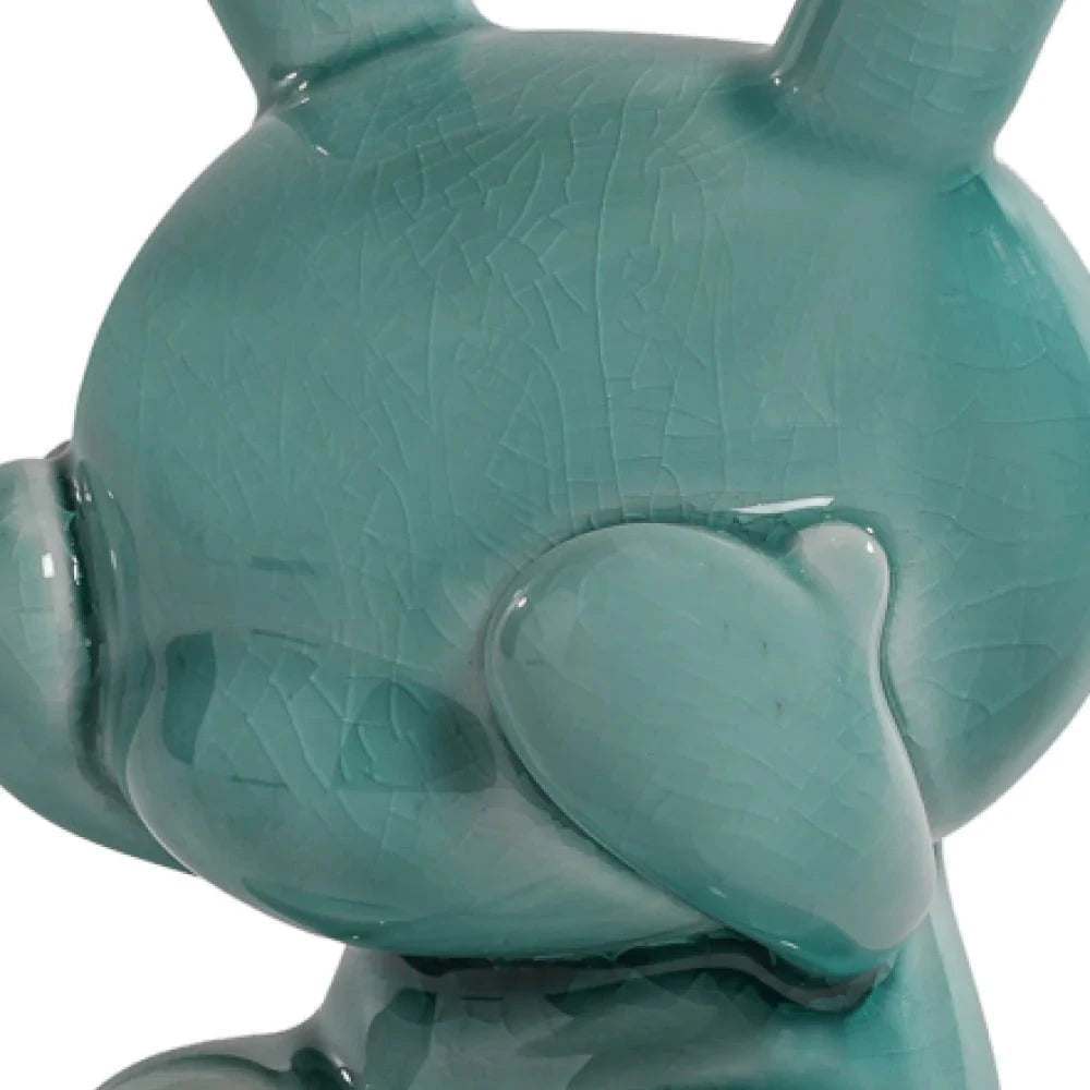 Close-up of a glossy, blue porcelain Kidrobot Three Wise Dunnys 5” from the Blue Mist Crackle Glaze Edition, featuring rounded ears and crackled texture.