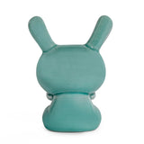 A blue mist crackle glazed Kidrobot Three Wise Dunnys 5” porcelain figure, viewed from the back with rabbit-like ears, showcases the brand’s iconic whimsical style against a plain white background.