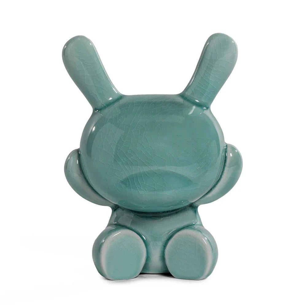 A blue-mist porcelain Dunny figurine with a round head and upright ears, seen from the back on white—part of Kidrobot (US)’s Three Wise Dunnys 5” Porcelain 3-Pack, Blue Mist Crackle Glaze Edition.