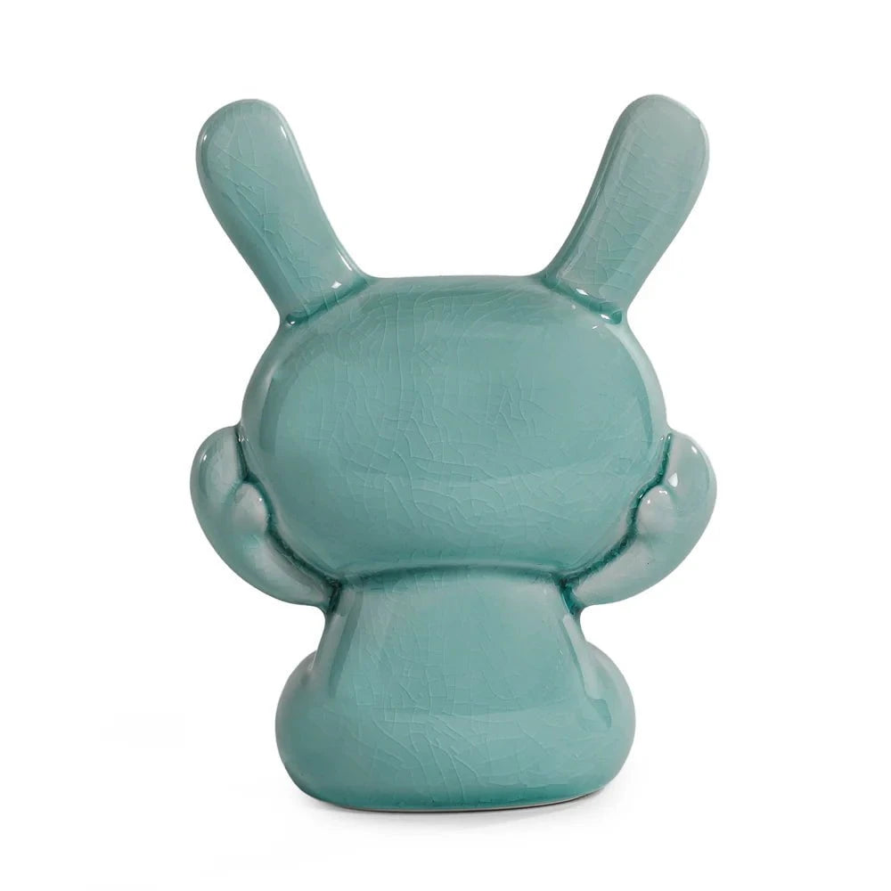 A Kidrobot (US) Three Wise Dunnys 5” Porcelain figure in Blue Mist Crackle Glaze, featuring two upright ears and a rounded body, is shown from the back against a white background.