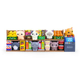 Bodega Kitties — Series 1 Blind Box by 100% Soft features miniature toy cats with surprise designs, displayed among colorful boxes and toy fruits, capturing the charm of a bodega and the excitement of discovering what's inside each blind box.