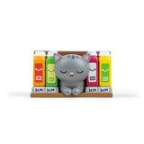 A gray cartoon cat figure from 100% Soft's Bodega Kitties — Series 1 Blind Box sits between four $4.99 juice cartons on a small bodega shelf—a fun collectible with a surprise design in each box.
