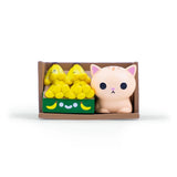 The 100% Soft Bodega Kitties — Series 1 Blind Box features a random small beige cat figurine and a box of smiling yellow bananas in a brown bodega crate, each set packaged as a blind box with assorted designs against a white background.