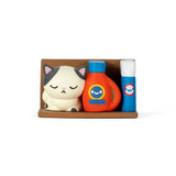 The Bodega Kitties — Series 2 Blind Box by 100% Soft features a small cat figurine, an orange bottle with a blue label, and a blue spray can on a brown tray, each with unique bodega-inspired designs.