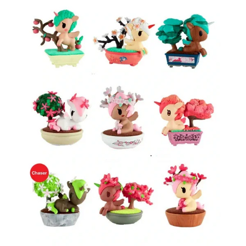 The Rotofugi Botanical Bonsai Unicorno Full Case features nine small, plant-themed deer figurines, each uniquely colored and displayed in its own pot.