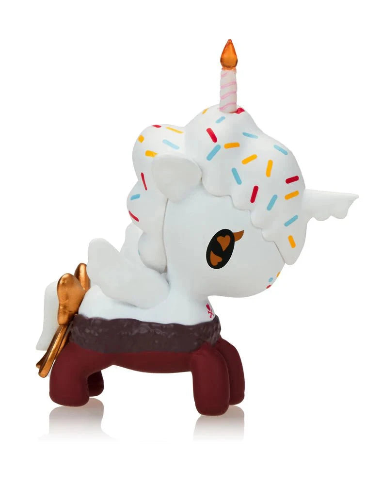 The Tokidoki Ice Cream Shop Unicorno Blind Box features a whimsical cupcake-inspired figure with a white body, colorful sprinkle spots, candle horn, golden wings, and red legs—perfect for fans of Tokidoki's cute collectible toys.