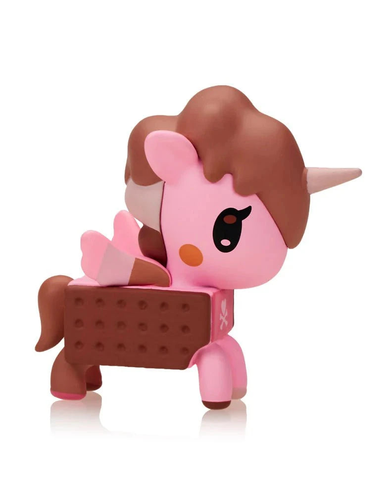 A Tokidoki Ice Cream Shop Unicorno Blind Box toy features a pink Unicorno with an ice cream sandwich body, brown mane, tail, and horn, plus a strawberry wafer-decorated wing.