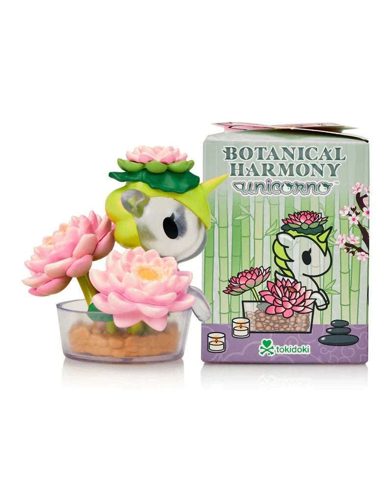 The Tokidoki Botanical Harmony Unicorno Blind Box features a small nature-inspired figurine with pink lotus flowers and leaves, displayed beside its matching floral box—an ideal addition for Tokidoki Blind Box Collectibles fans.